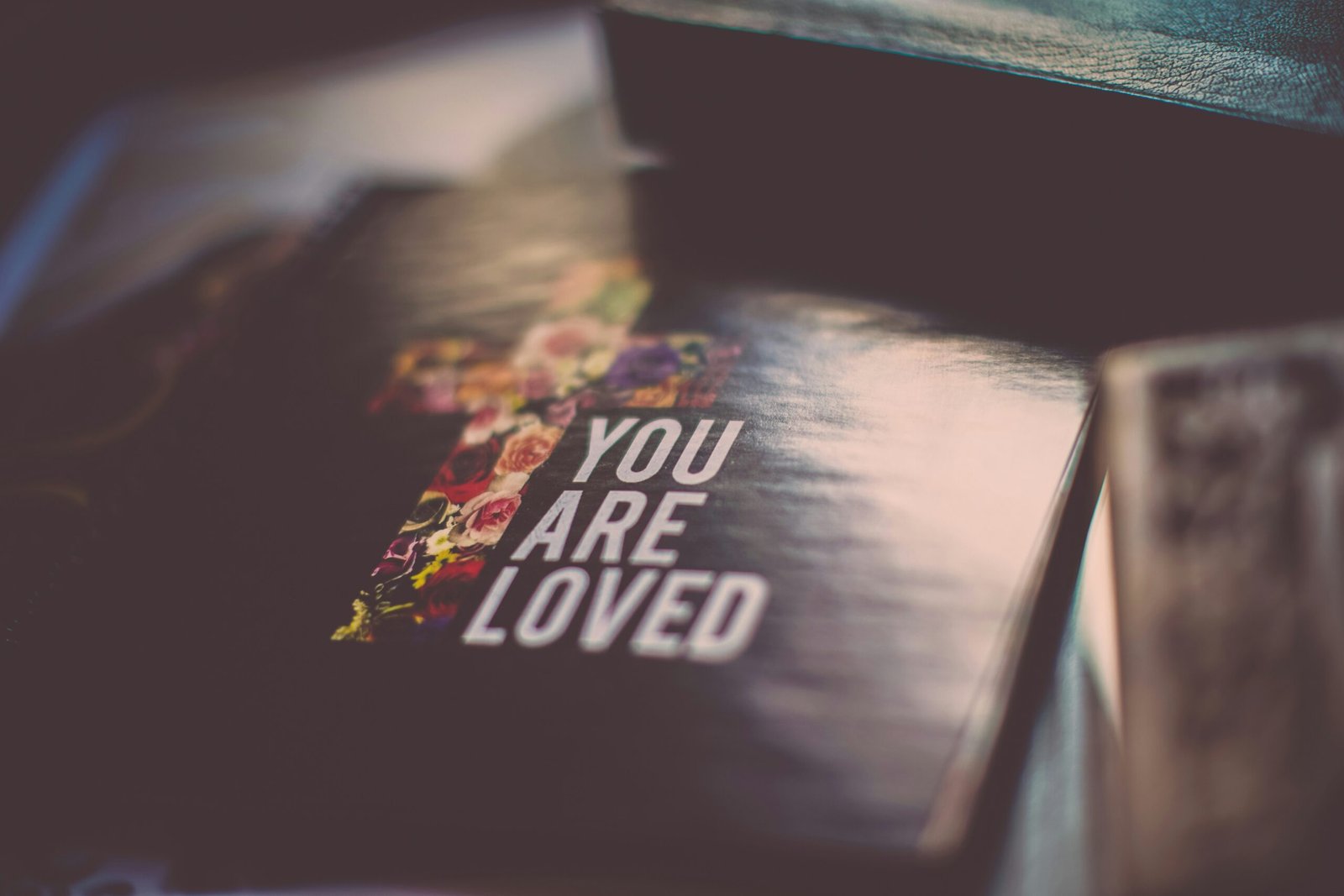 selective focus photography of You Are Loved book scaled